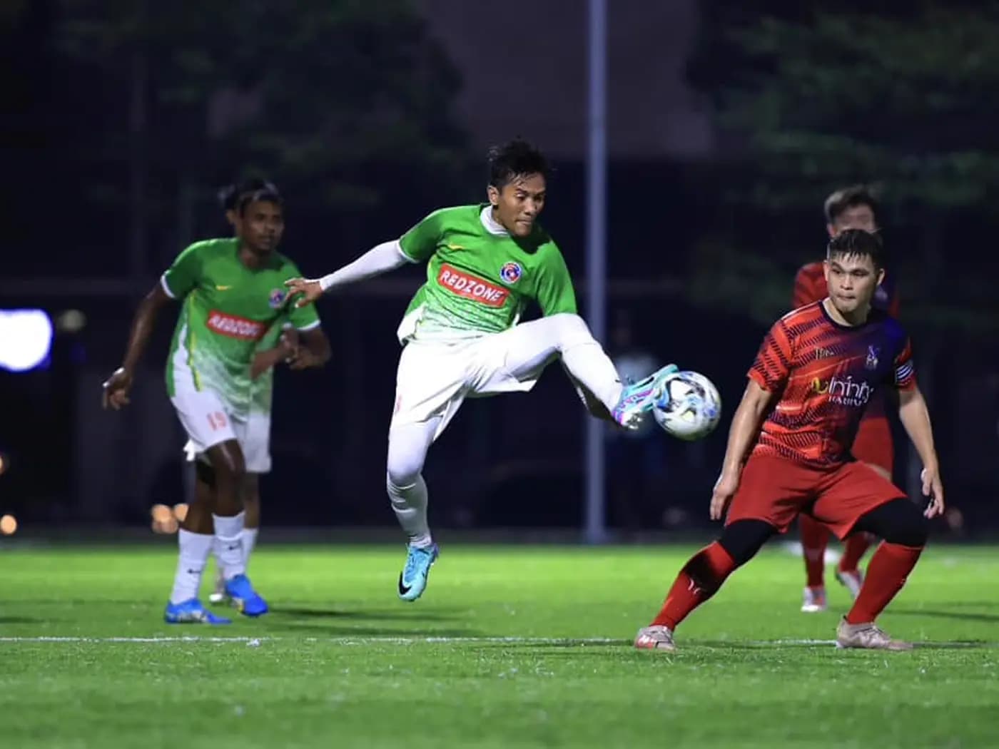 A flying kick surrounded by players at ArmourX Sports