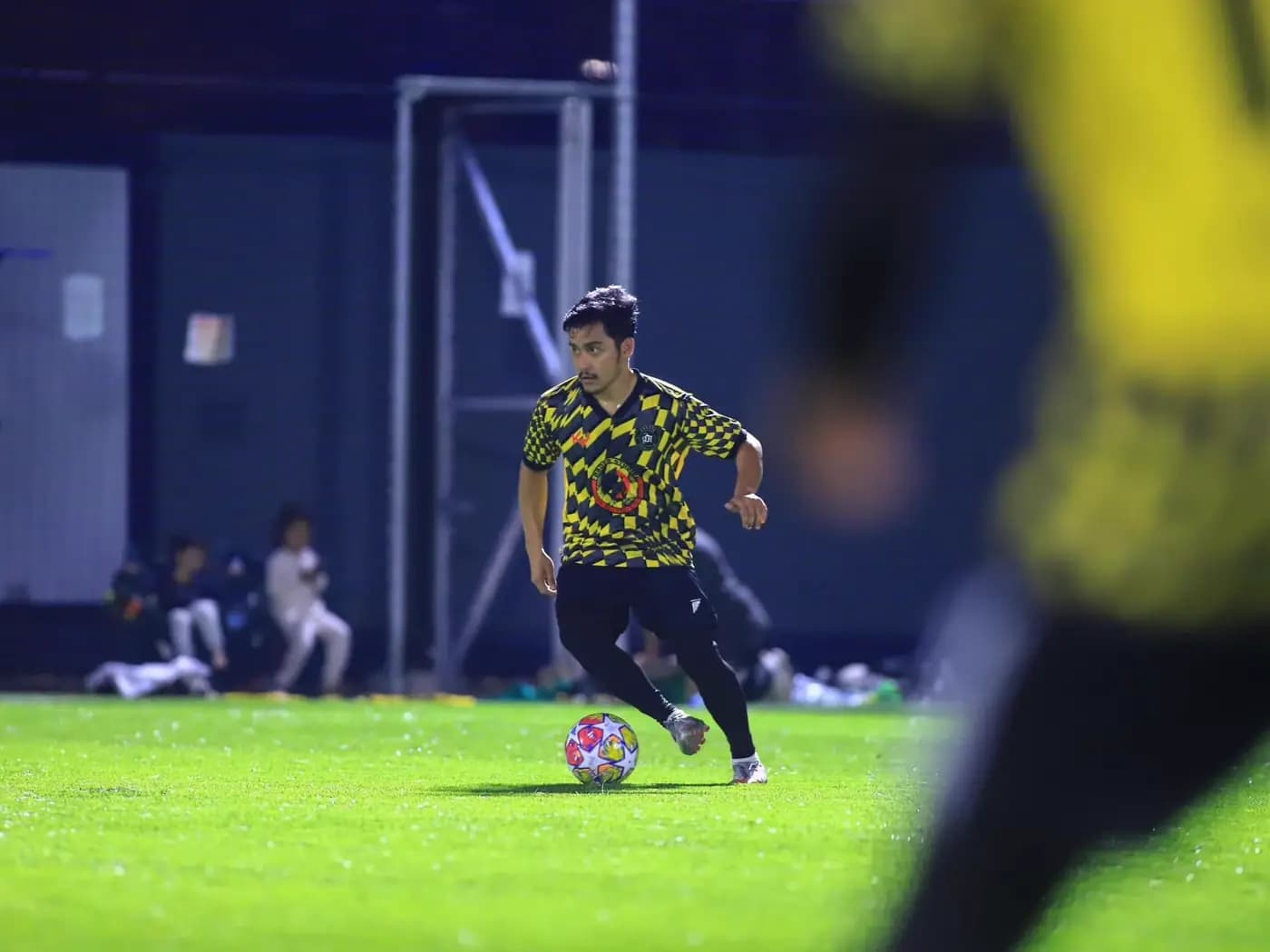 A player rushing forward with the ball at ArmourX Sports