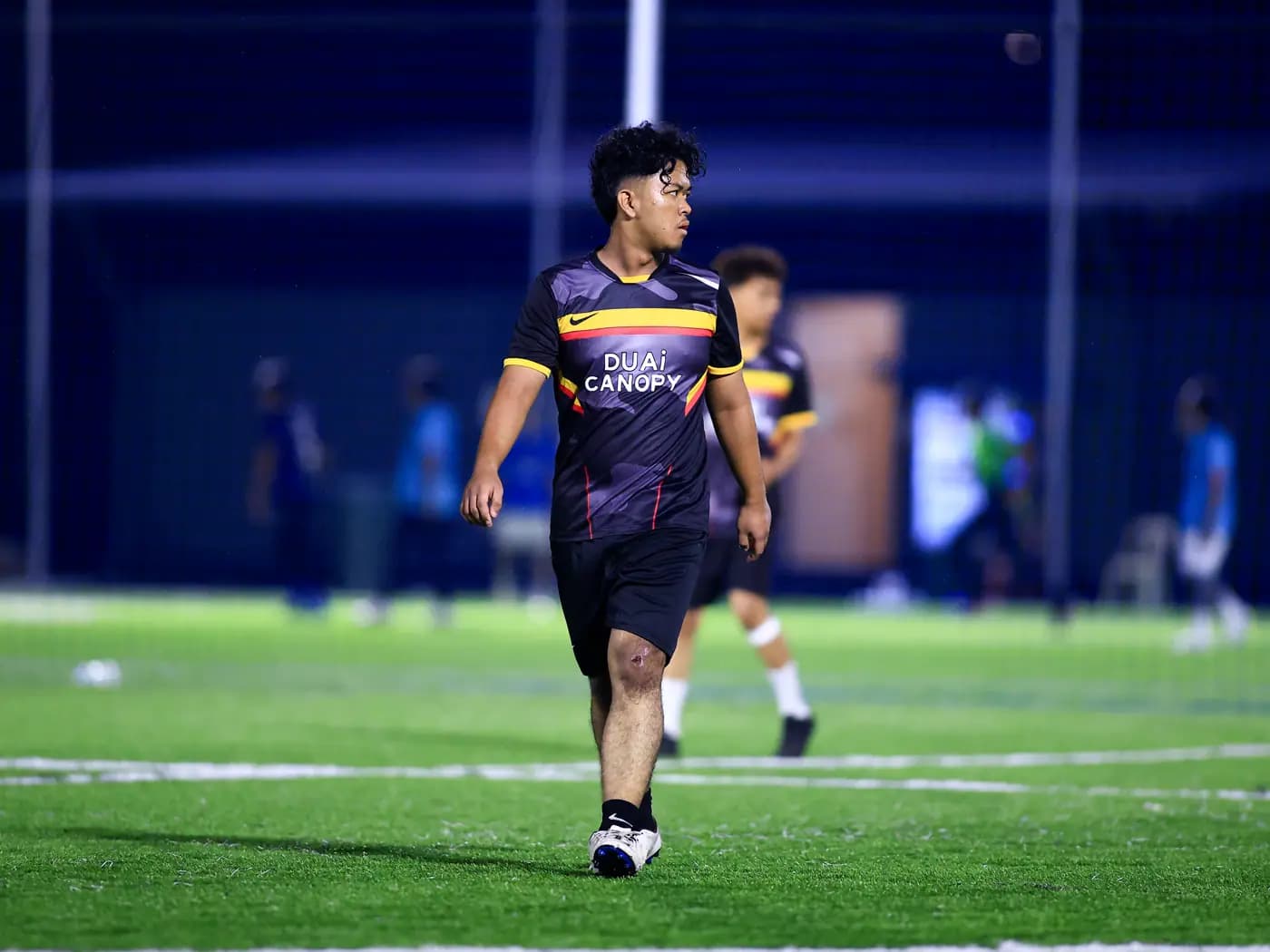 A player walking between the play with a proper pose at ArmourX Sports